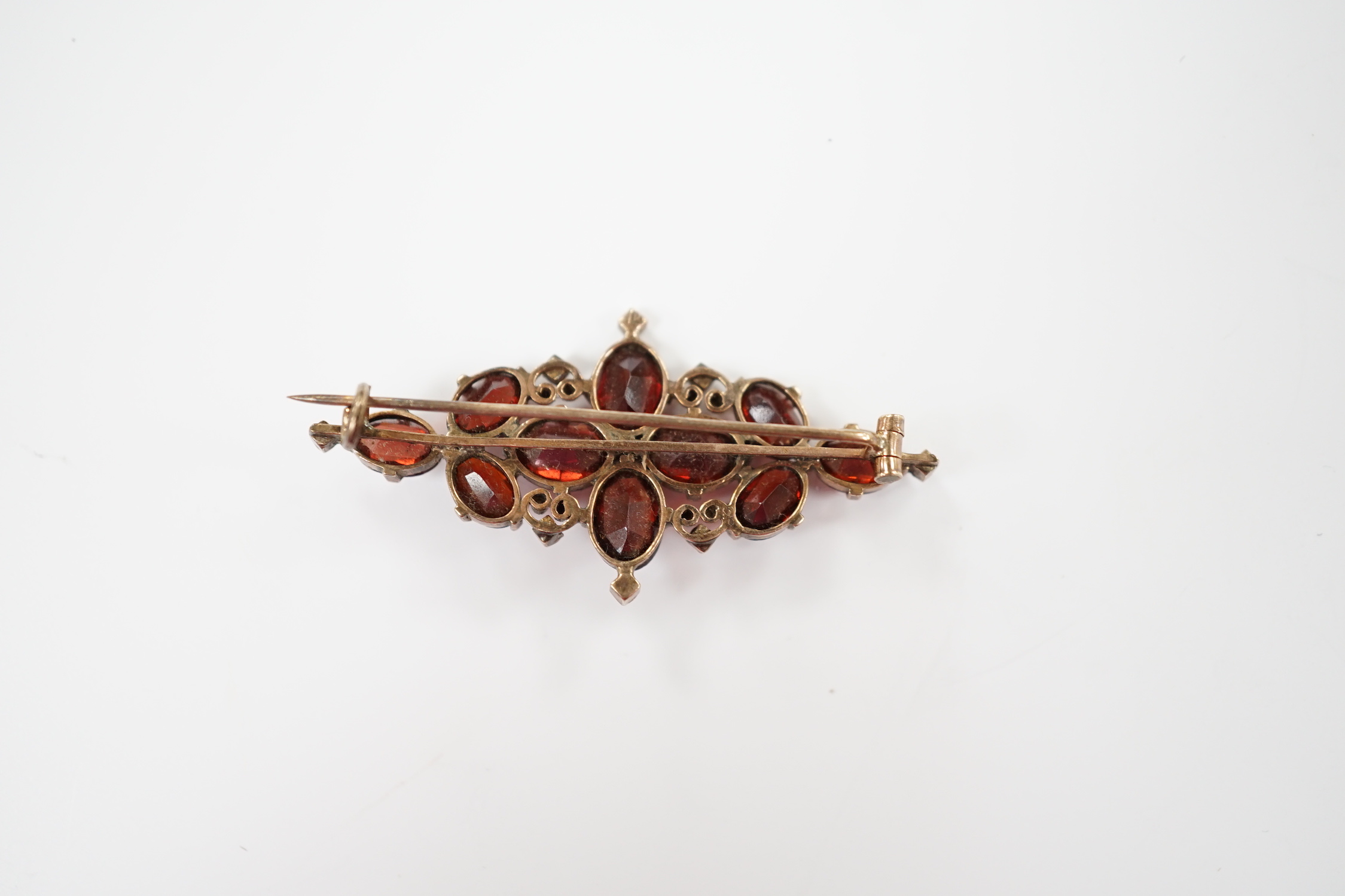 A Victorian yellow metal, garnet and seed pearl cluster set brooch, 44mm, gross weight 4.8 grams.